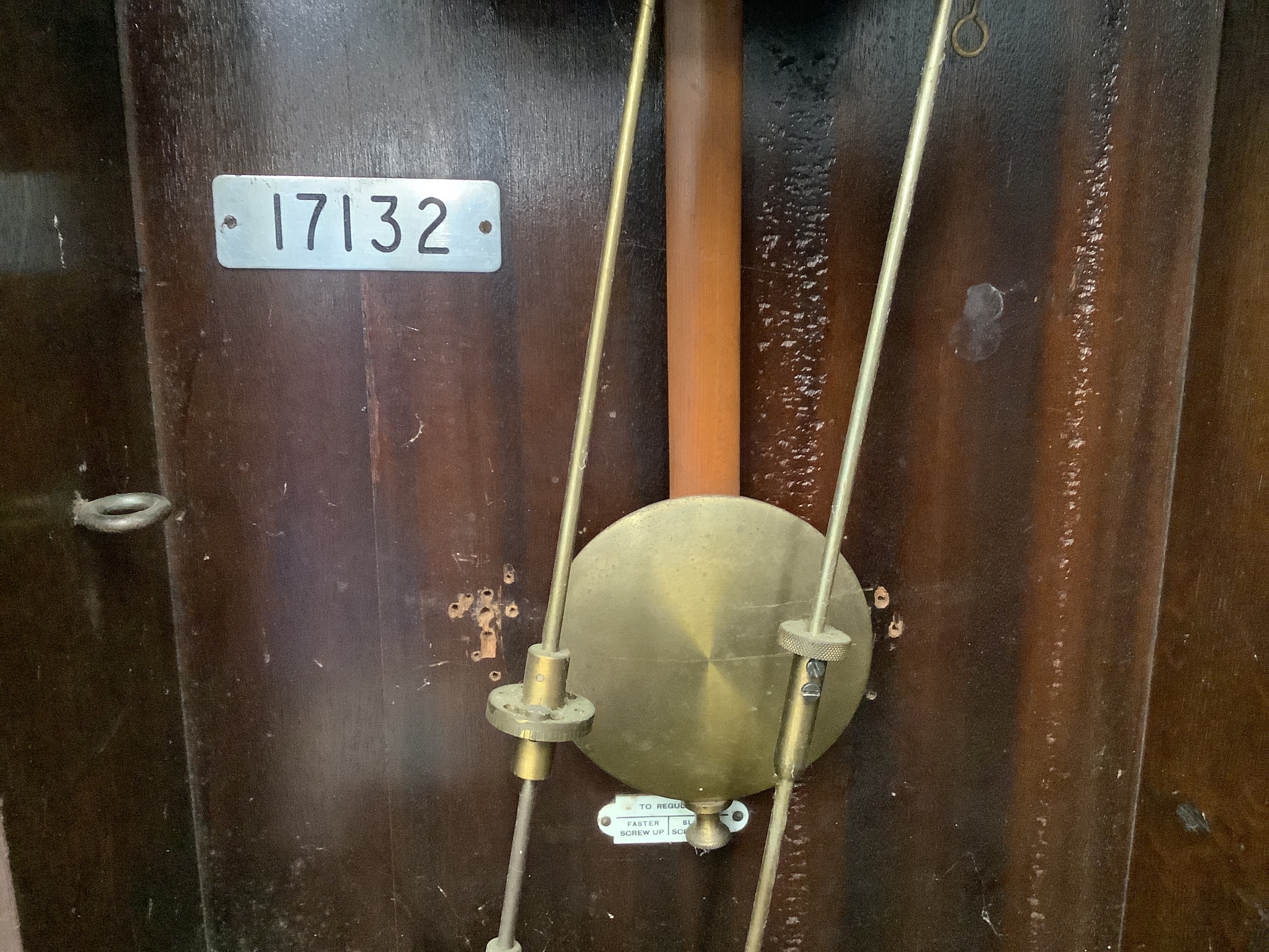 An early 20th century oak cased clocking in clock, height 116cm